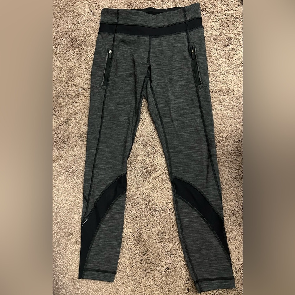 Lululemon leggings in heather dark grey with mesh detailing and zipper pockets